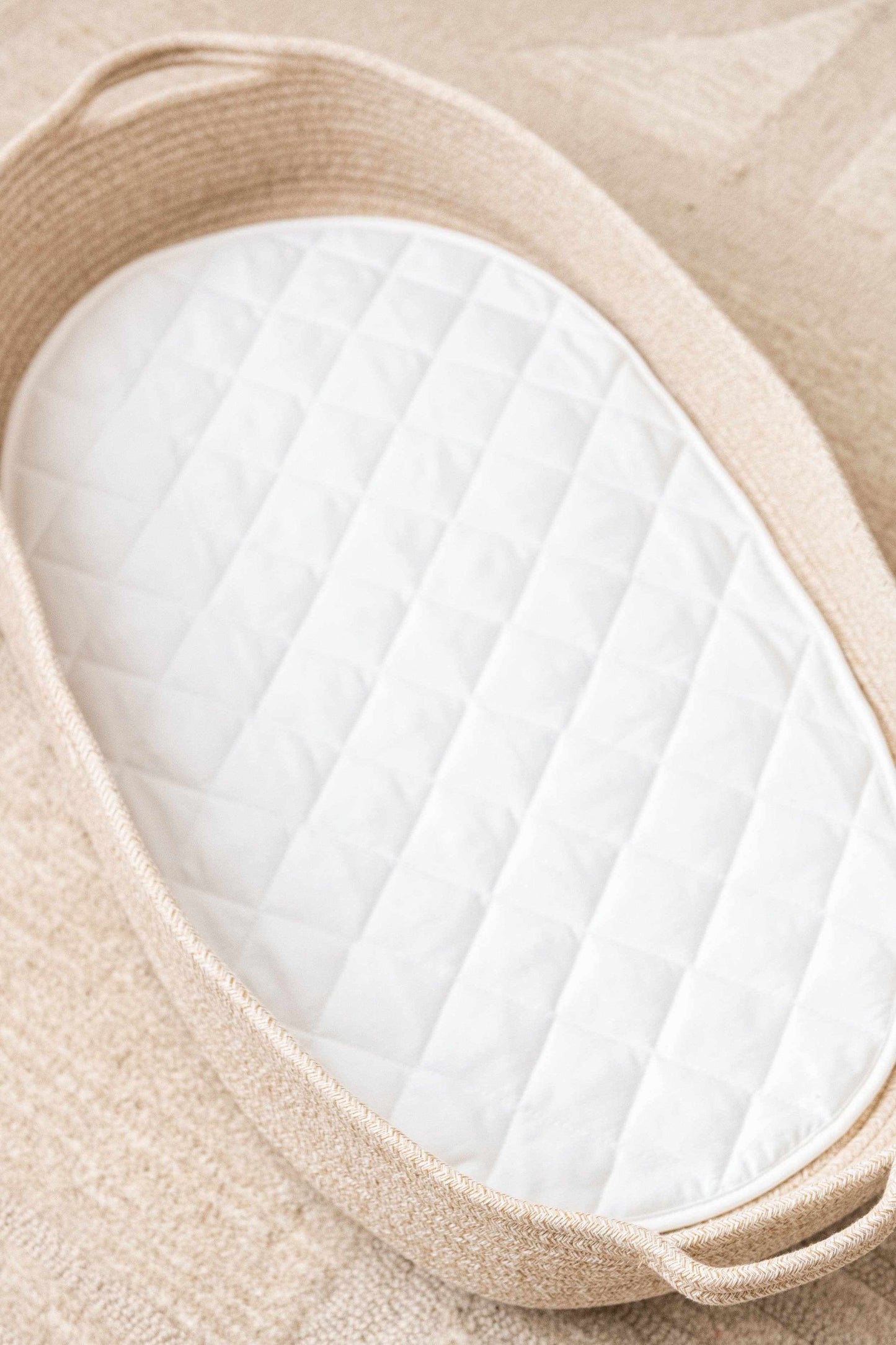 Kiin cotton rope change basket with white quilted cotton liner on beige rug