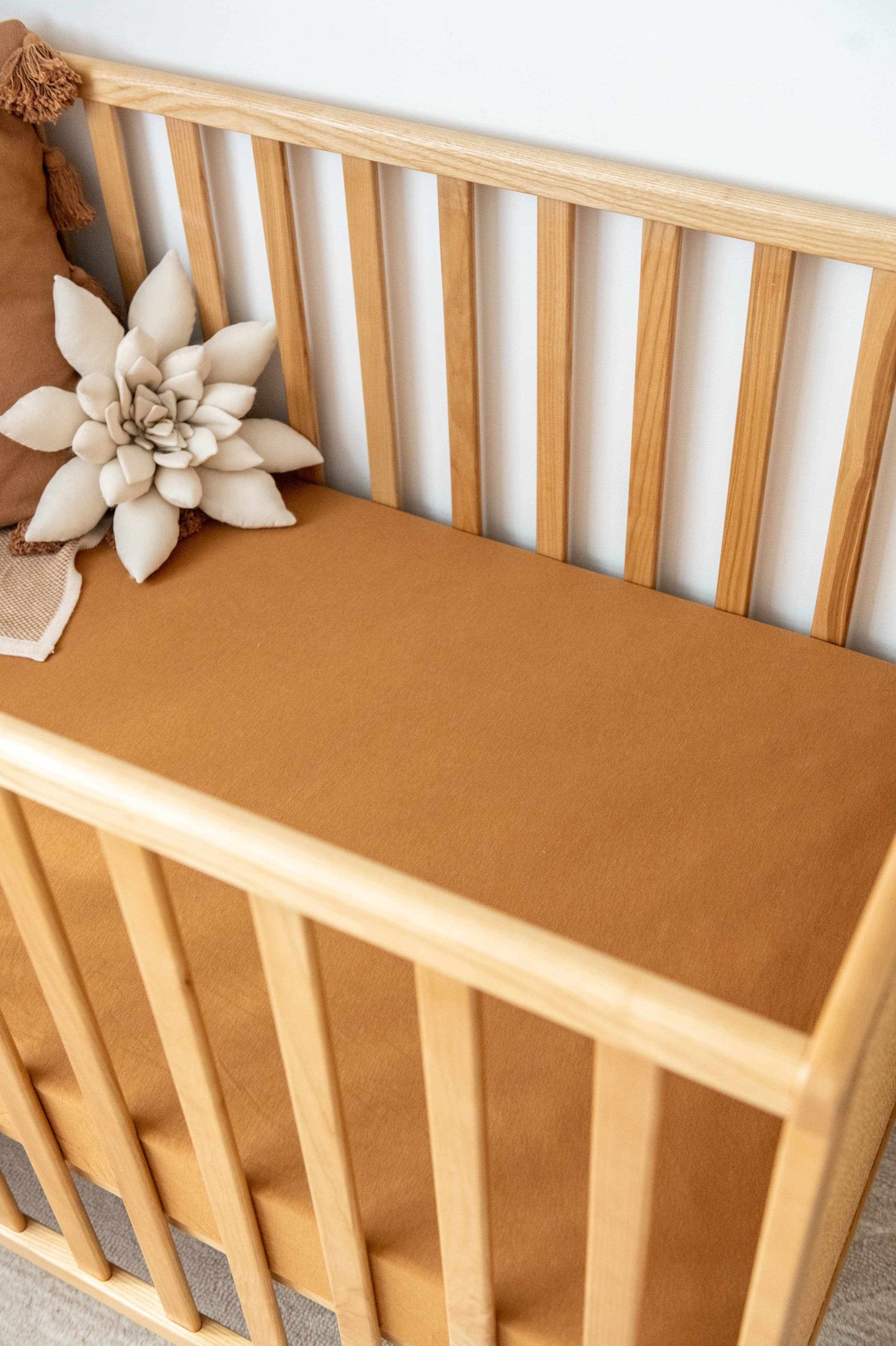 Kiin Organic Cot Sheet soft breathable bamboo cotton blend fitted sheet in brown on wooden cot