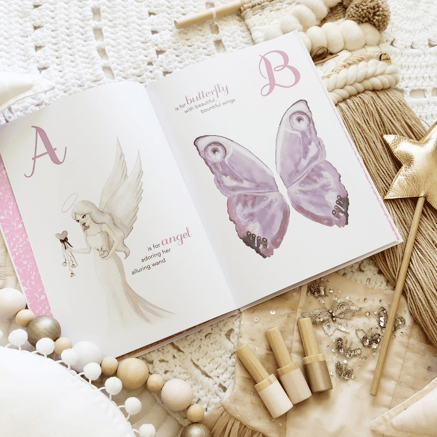 Open The Enchanting ABC children's book showing illustrated angel and butterfly pages with whimsical design and soft pastel colors on cozy background