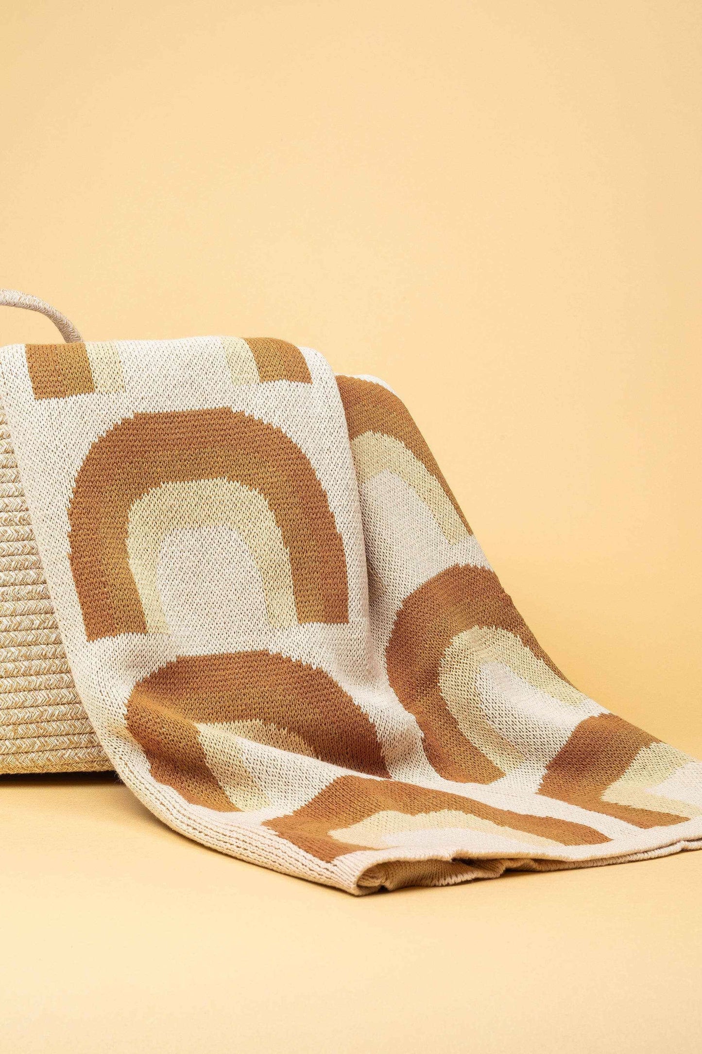 Kiin Organic Cotton Knitted Blanket with beige and brown rainbow pattern, soft breathable 100% organic cotton baby blanket.