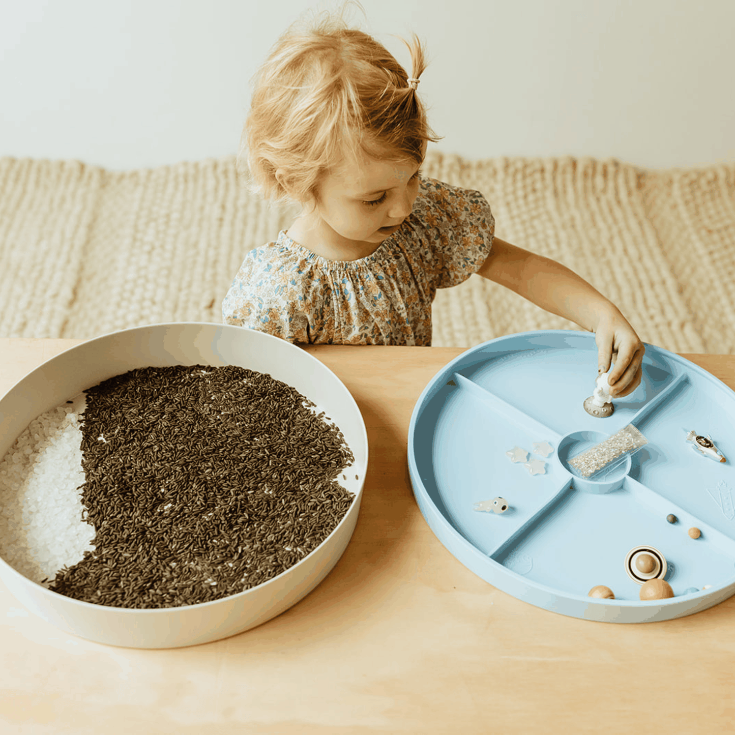 Child playing with Sensory Kits Galaxy featuring black rice, stars, and space-themed items for imaginative play