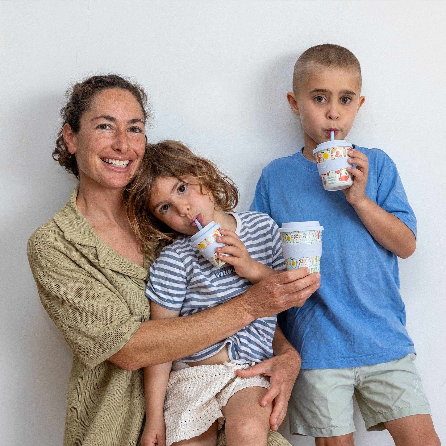 Mother with two children using Amalfi Kids Keep Cup 8oz with colorful patterns and straws