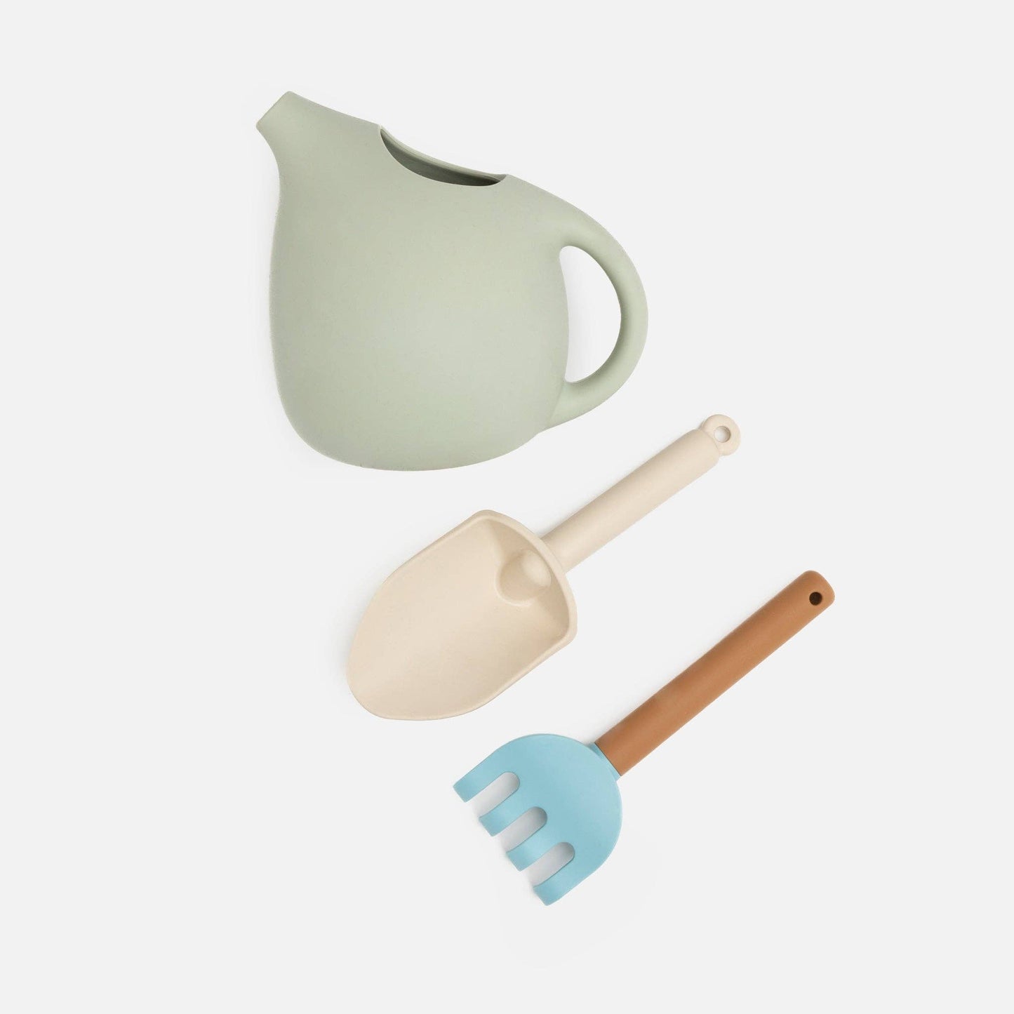Kynd Silicone Gardening Set with green watering can, beige shovel, and blue rake for kids safe play