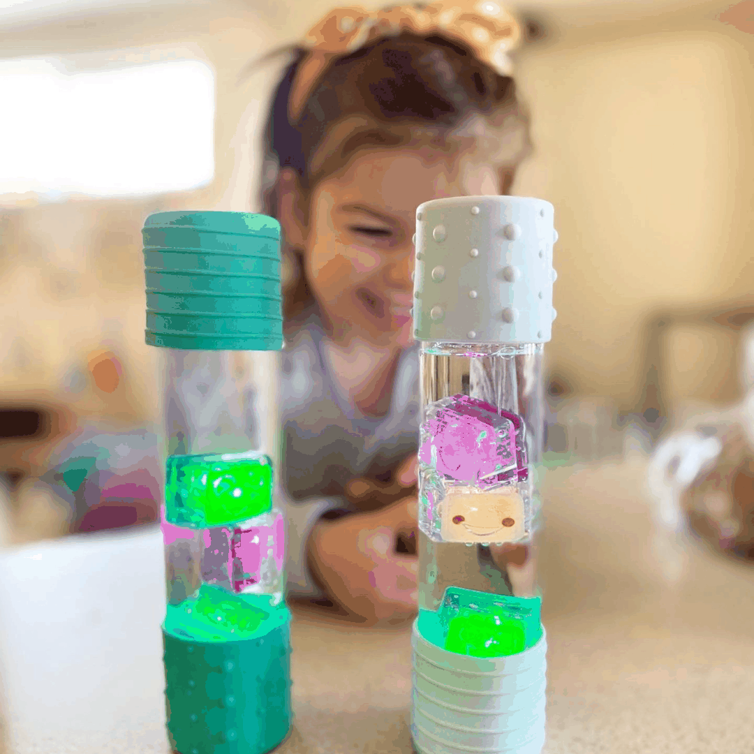 Child playing with Sammy the Glo Pal light-up cubes in clear tubes for sensory water play
