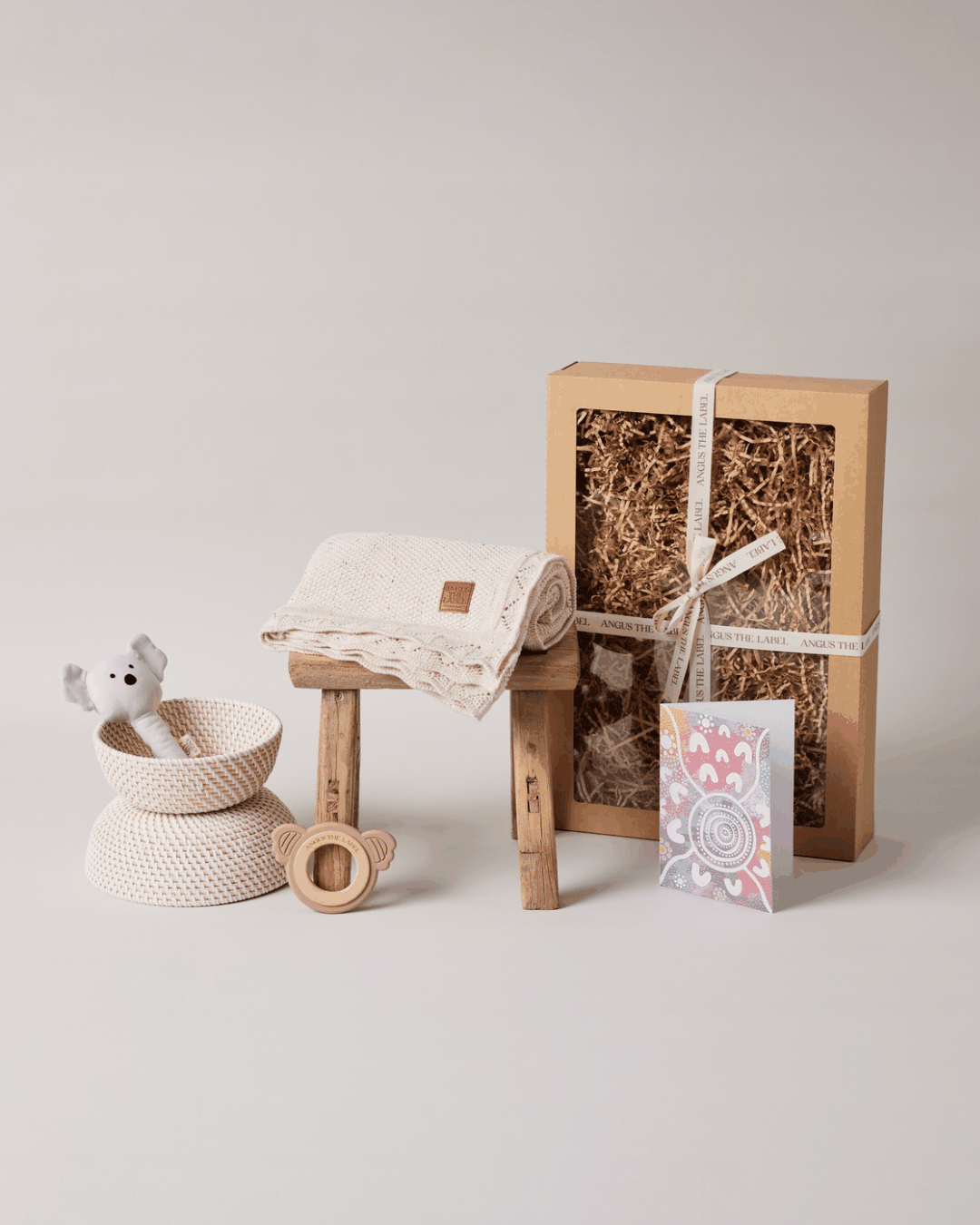 Cosy Joy Baby Gift Set with cotton blanket, plush bunny rattle, silicone teething ring, and gift card in eco-friendly packaging