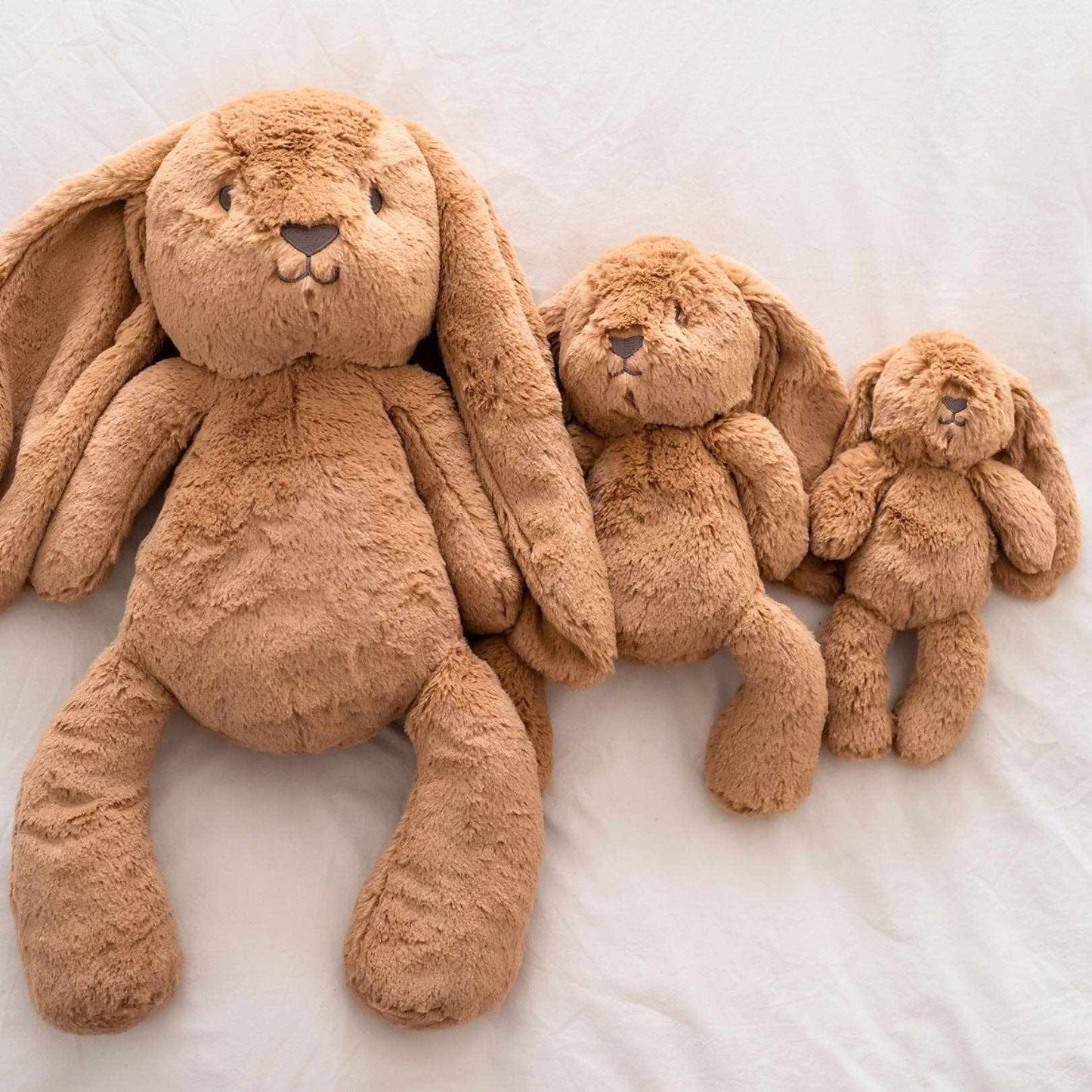 Little Bailey Caramel Bunny plush soft toy in caramel color with floppy ears, available in three sizes.