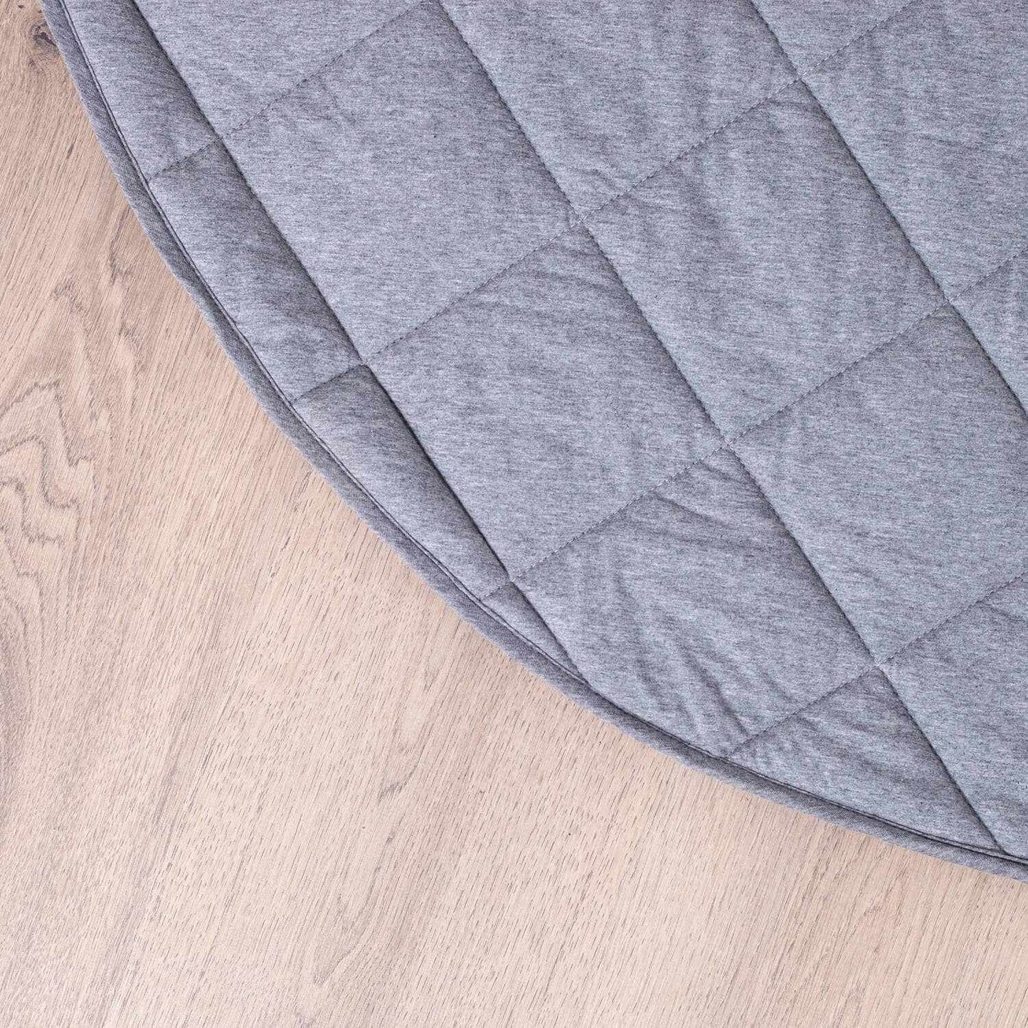 Grey jersey quilted play mat with waterproof backing on wooden floor