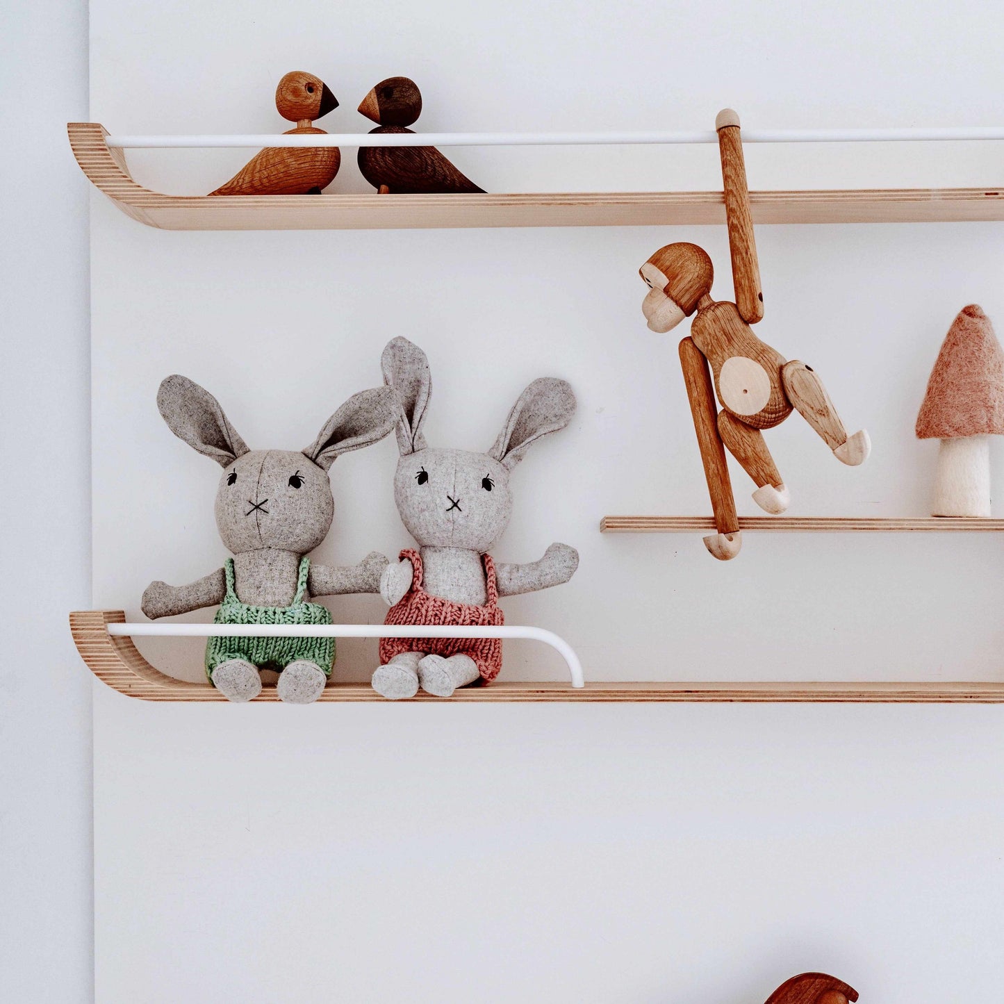 Agatha the Bunny stuffed animal with floppy ears and soft fabric sitting on wooden shelf with toys