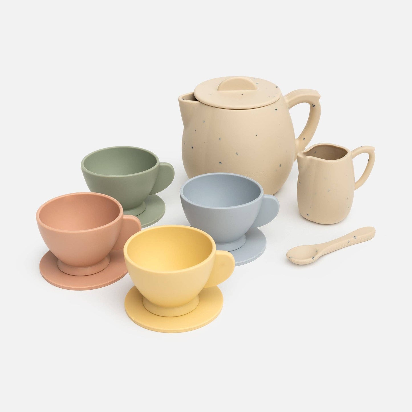 A silicone tea party set in soft colors including beige, green, blue, pink, and yellow, consisting of a pitcher, cups, saucers, and a spoon.