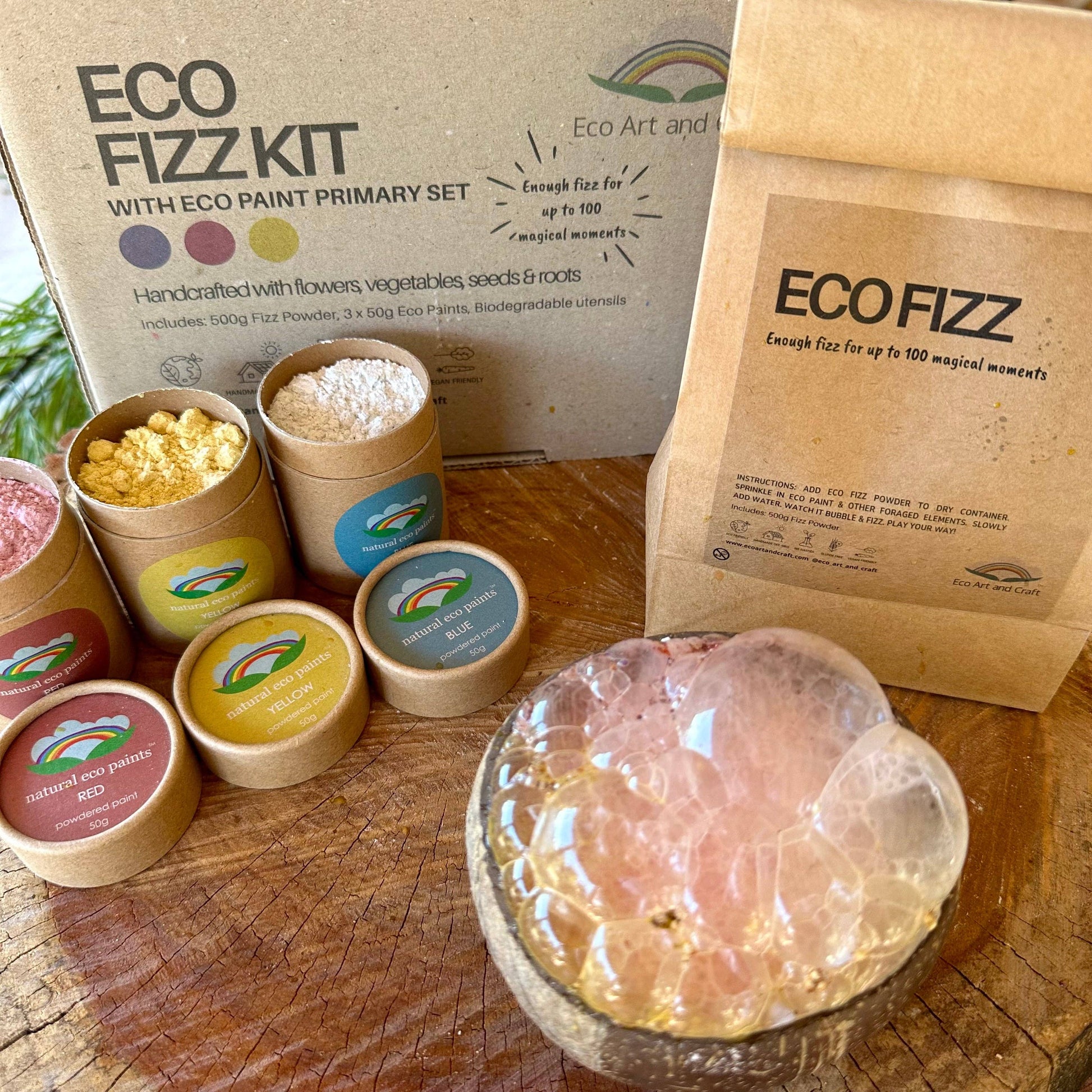 Eco Fizz Kit with various containers and a crystal on a wooden surface
