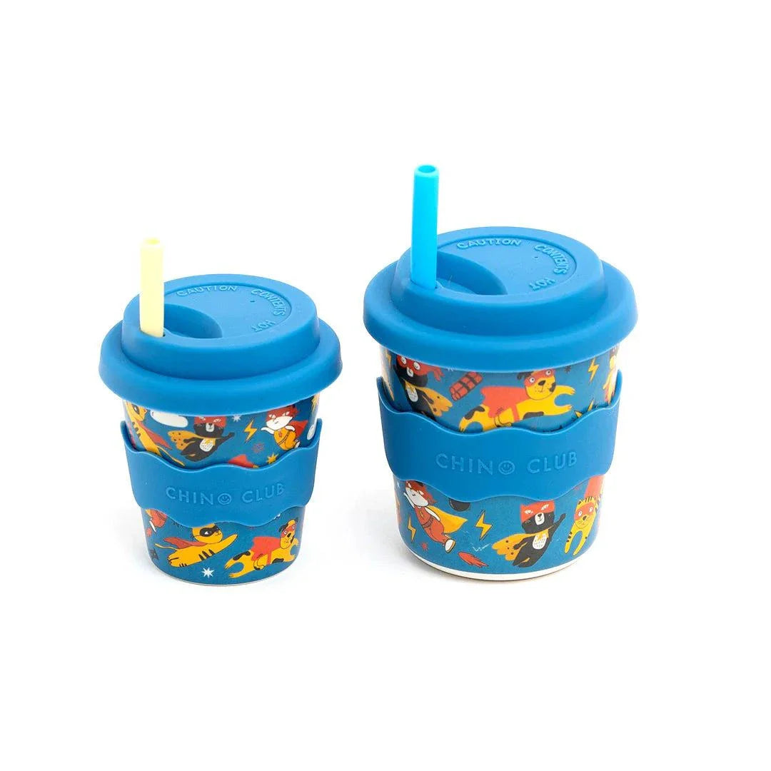 Two Superhero Babychino Cups with silicone lids and superhero designs, perfect for eco-friendly babychinos or water on-the-go.